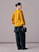 Back view of the mustard gold floral jacquard Chinese blouse with three-quarter sleeves