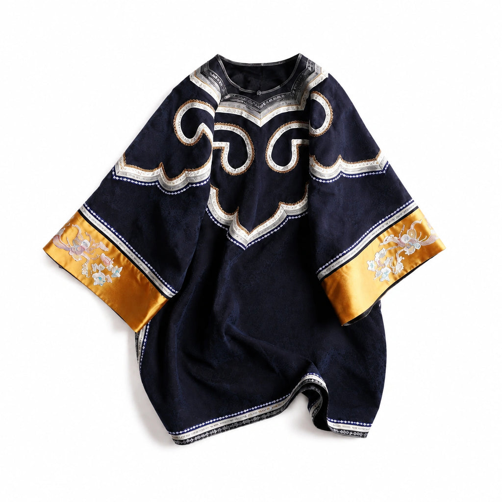 Product view of the midnight navy silk tunic dress with ivory scroll trim and antique-gold floral cuffs