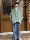 Full-length outfit featuring the Ningyuan sage green coat, blue wide-leg trousers and silver shoes.
