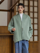 Front view of the Ningyuan coat showing its relaxed fit, dropped shoulders and single decorative button.