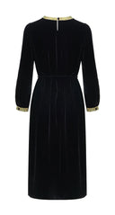 Back view of the black velvet midi dress with long sleeves and a tie waist
