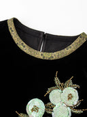 Close-up of the patterned round neckline and floral sequin embellishment