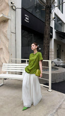 Side view of an olive green short-sleeve Cheongsam blouse, showcasing the relaxed fit and viscose blend fabric.