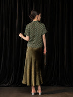 Back view of the olive green high-sheen fishtail skirt styled with a short Chinese-style top