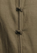 Close-up of the decorative frog buttons and textured olive green fabric