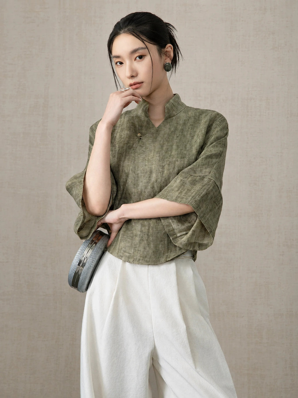 Woman wearing the Olive Green Linen Mandarin Collar Blouse by Gambiered Silk.