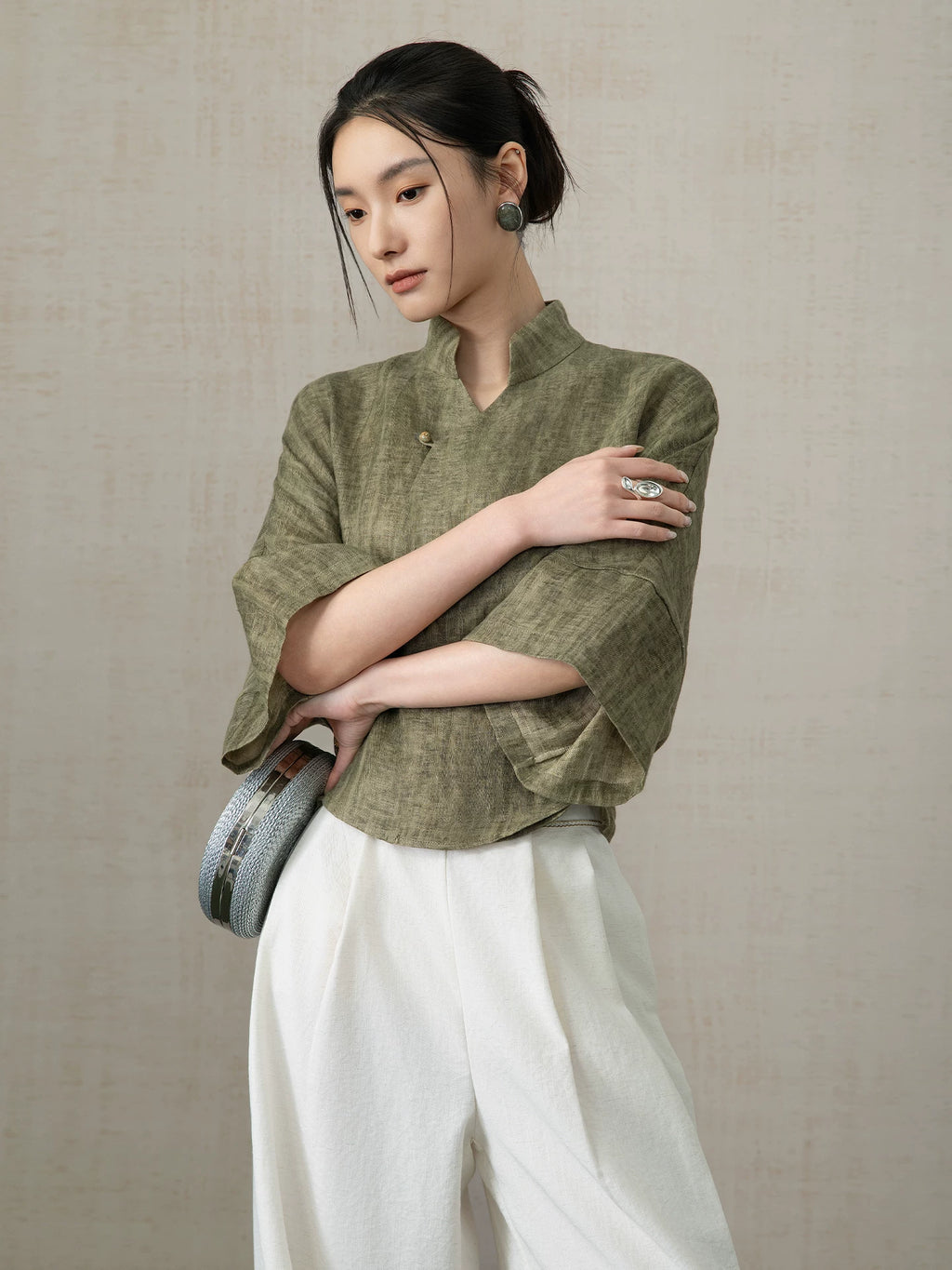 Side view of the Olive Green Linen Mandarin Collar Blouse in premium linen.
