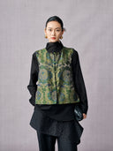 Front view of the olive green jacquard vest featuring a round beaded neckline