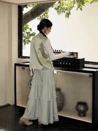 Back view of a pale green Shu Jin silk Chinese vest with a stand collar and soft satin finish.