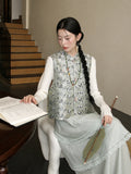 Close-up of a pale green mulberry silk vest showing its bear pattern, stand collar, and decorative closures.
