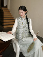 Close-up of a pale green mulberry silk vest showing its bear pattern, stand collar, and decorative closures.