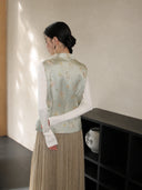 Back view of a pale mint Songjin silk Chinese vest featuring cat and butterfly motifs with a stand collar.