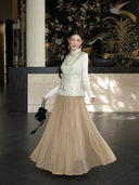 Full-body styling of a pale mint cat and butterfly Songjin silk vest paired with a champagne pleated skirt.