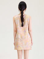 Back view of a model wearing a peach floral viscose sleeveless top and matching short skirt.