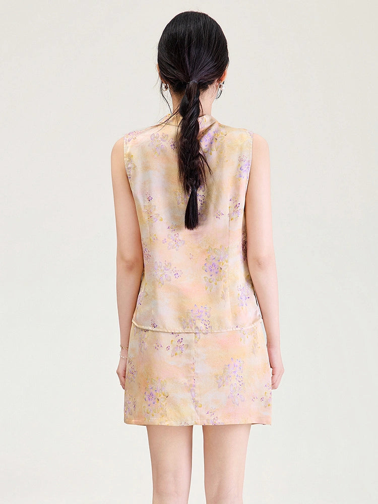 Back view of a model wearing a peach floral viscose sleeveless top and matching short skirt.