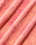 Close-up of the peach and pink mottled fabric texture