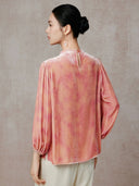 Back view showing the peach pink print and buttoned keyhole opening