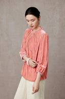 Side view showing the blouse’s relaxed fit and softly gathered sleeve