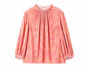 Front view of a peach pink blouse with fine neckline pleats and gathered cuffs