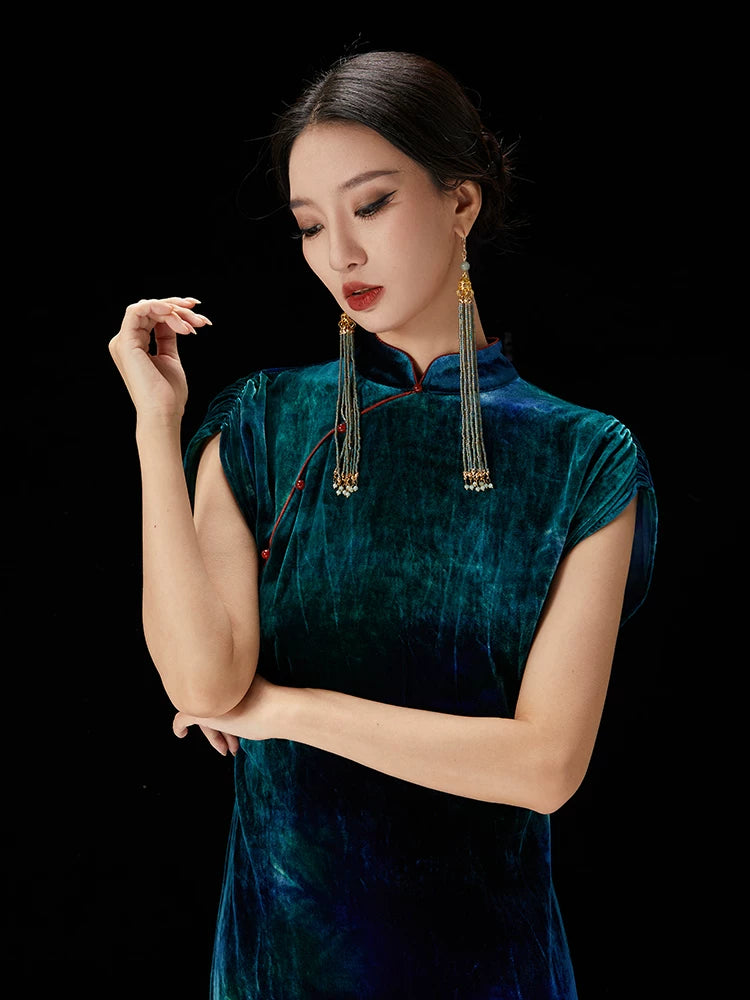Close-up of the peacock teal velvet qipao dress highlighting the mandarin collar and silk-blend fabric texture.