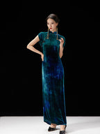 Peacock teal velvet-inspired qipao dress styled with traditional frog-button details.