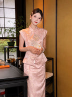 Model wearing a pink cap-sleeve Cheongsam top with silver sequin embroidery and a matching skirt, holding a white fan in a tea room setting.