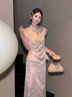Side view of a pink cap-sleeve Cheongsam top with silver bead embroidery, styled with a matching skirt and a gold handbag.