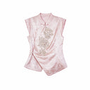 Flat lay of a pink cap-sleeve Cheongsam top with a mandarin collar, silver sequin floral embroidery, and an asymmetric hem.