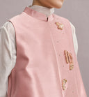 Detail of the pink vest’s stand collar, smooth fabric and decorative butterfly motifs