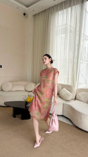 Model wearing a pink floral jacquard Cheongsam dress with a button-down front, styled with pink heels and a matching handbag.