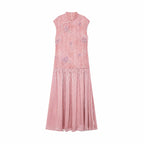 Flat lay of a pink Cheongsam dress with a mandarin collar, floral embroidery, beaded trim, and a pleated skirt, crafted from 100% polyester.