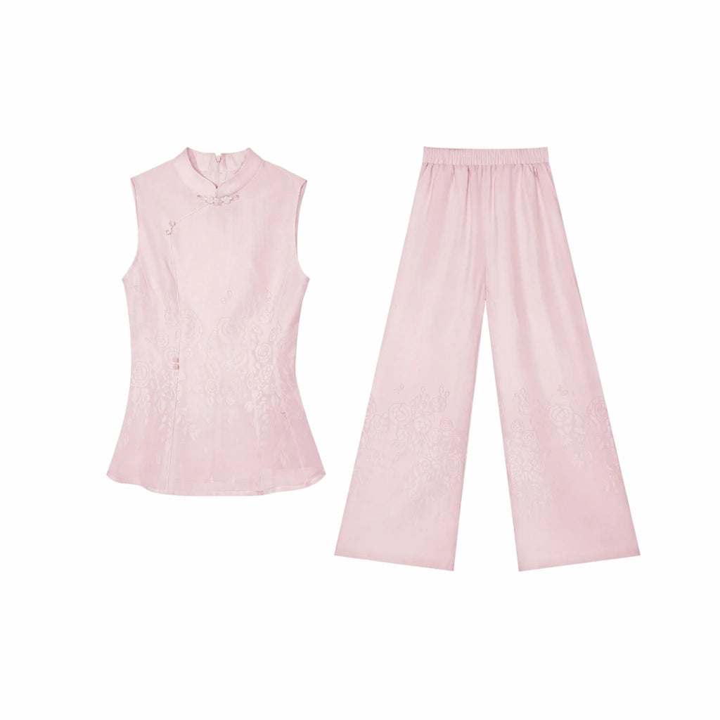 Flat lay of a pink Cheongsam style blouse and trousers set, showcasing the relaxed fit and lace details on the pants.