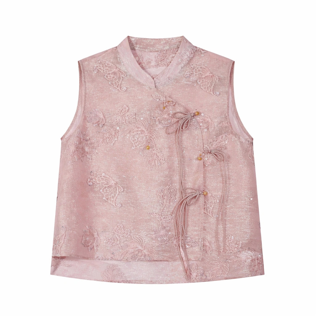Flat lay of a pink sleeveless embroidered vest with a mandarin collar, floral embroidery, and side tie details.
