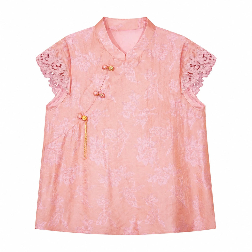Flat lay of a pink jacquard blouse with a mandarin collar, lace cap sleeves, and a side button closure, crafted from 80% Viscose and 20% Polyamide.