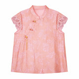 Flat lay of a pink jacquard blouse with a mandarin collar, lace cap sleeves, and a side button closure, crafted from 80% Viscose and 20% Polyamide.