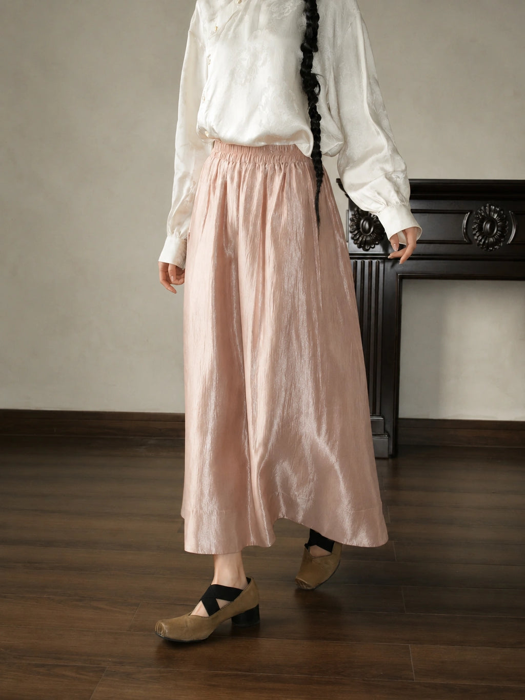 Front view of a pink high-waist A-line skirt with a standard fit, natural drape, and subtle shine.