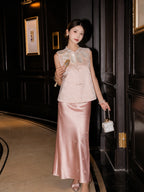 Model in a pink floral jacquard vest with pearl buttons and a scalloped collar, holding a fan and handbag, crafted from a Polyester-Lyocell blend.