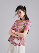 Side view of the pink Xiangyunsha top featuring colorful koi motifs and a scalloped hem