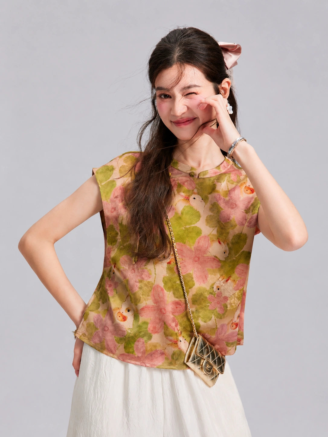 Front view of a woman wearing the pink rabbit and floral 100% mulberry silk top