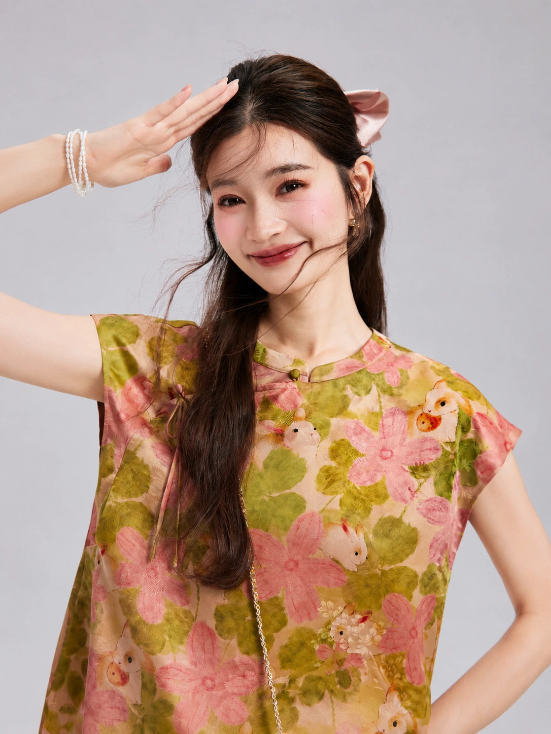 Close-up of the pink flowers, olive foliage and rabbit print on the Xiangyunsha silk top