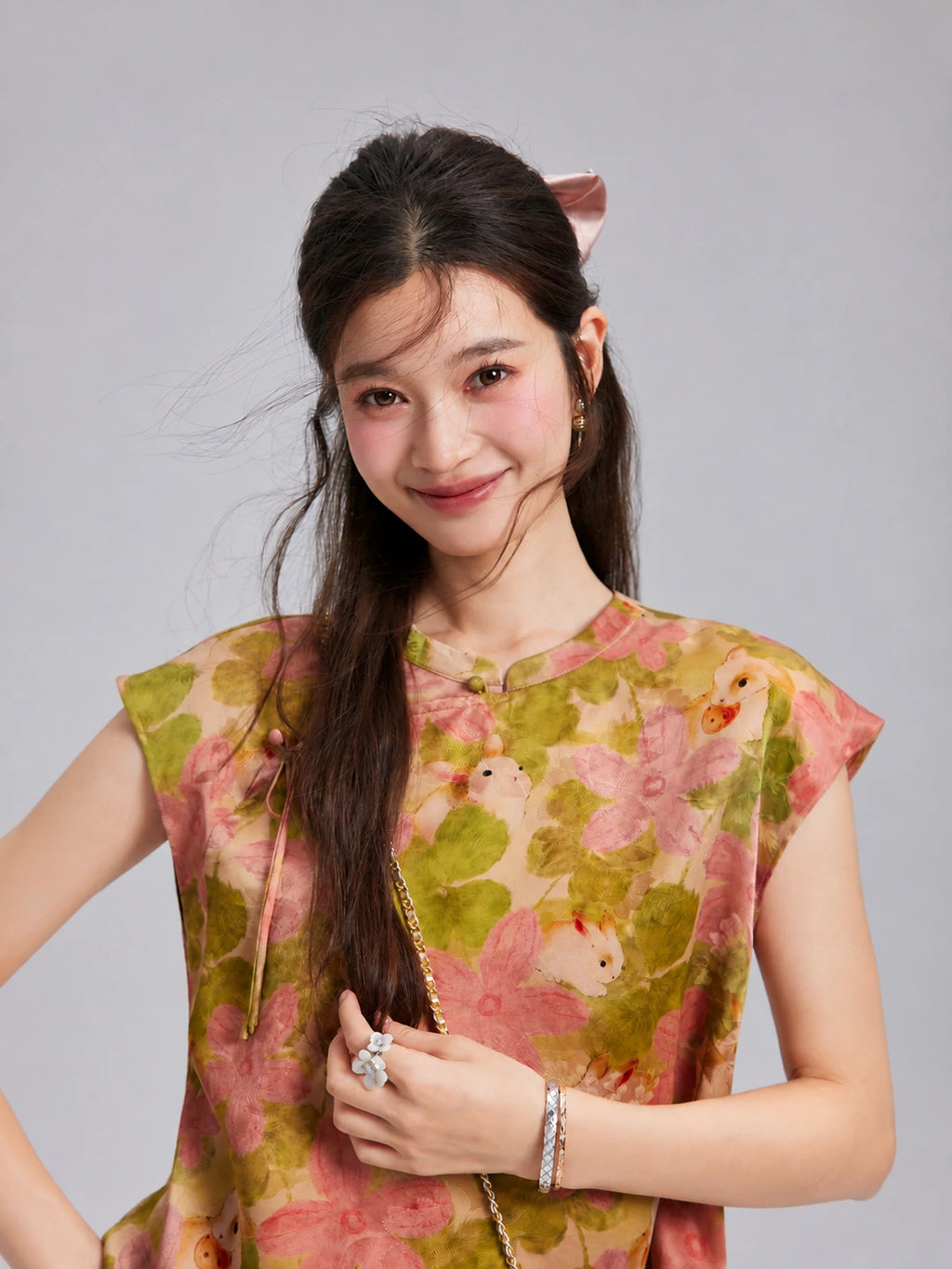 Close-up of the round neckline and side-button detail on the rabbit floral Xiangyunsha silk top