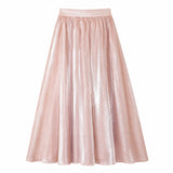 Flat lay of a pink shiny maxi skirt with an elastic waistband and flowy silhouette, crafted from 100% polyester.