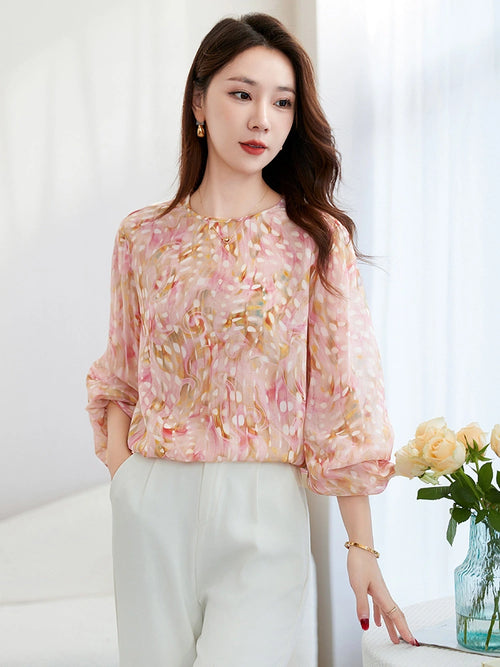 Front view of a pink printed silk blouse with lantern sleeves, featuring a lightweight and breezy silhouette, perfect for summer styling.
