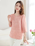 Side view of a pink silk-blend top with loose sleeves and side slits, highlighting the flowy and elegant silhouette.