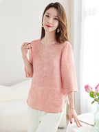 Side view of a pink silk-blend top with loose sleeves and side slits, highlighting the flowy and elegant silhouette.