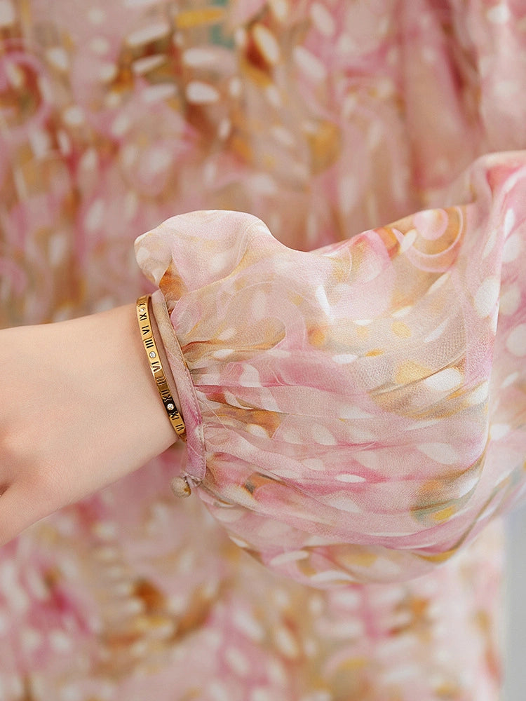Close-up of a pink and gold abstract printed silk sleeve with a gathered lantern design, crafted from 100% Mulberry Silk.
