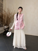Model wearing a medium-length pink Zhangduan silk vest with a flowing white skirt and traditional Chinese styling.