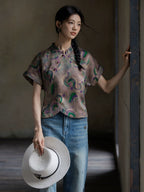 Model wearing a printed mulberry silk Gambiered Silk blouse with modern Chinese-inspired details.