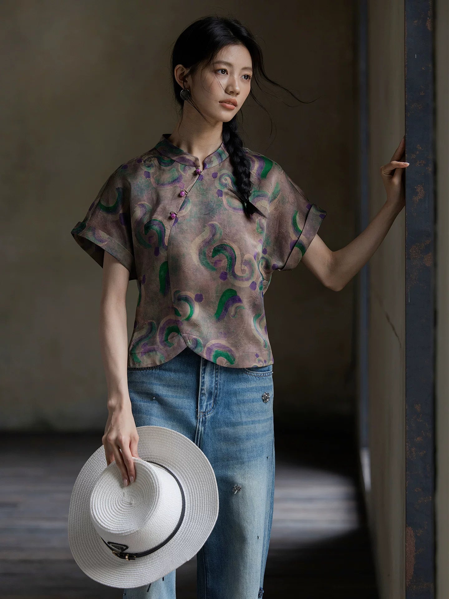 Model wearing a printed mulberry silk Gambiered Silk blouse with modern Chinese-inspired details.
