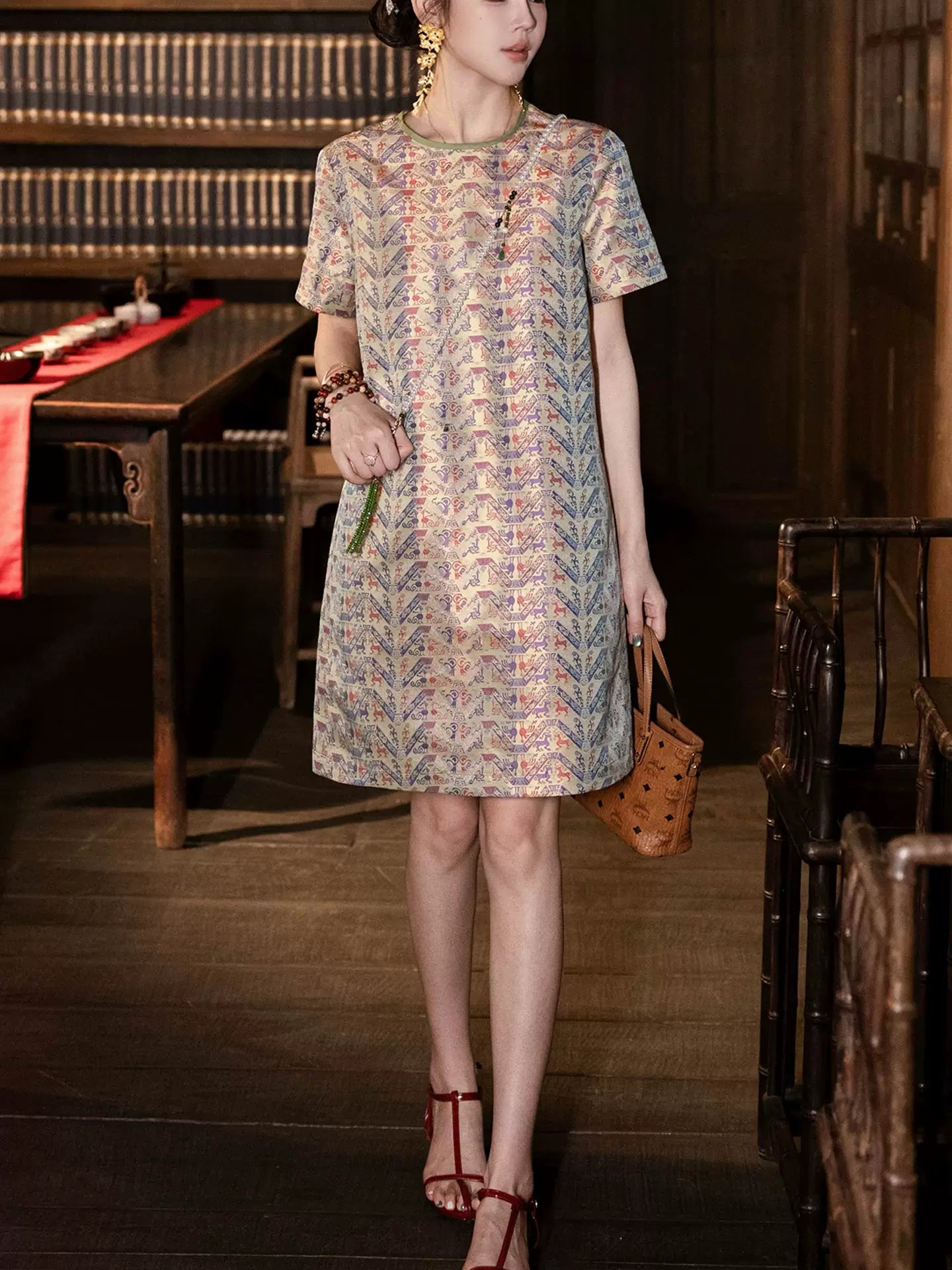 Full-length view of a model in a relaxed pure silk Chinese-inspired dress with short sleeves